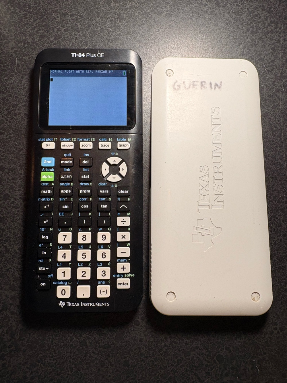 Texan Instruments TI-84 Plus CE graphing calculator in black and white